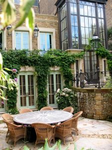 Romantic-garden-with-window-surrounds,-hard-lanscaping-and-furniture-in-a-range-of-stones-and-treatments